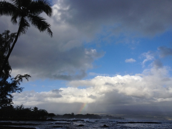 Behind the rainbow, hidden (as usual) by the clouds, Mauna Kea rises 13,796 feet above the Pacific Ocean.